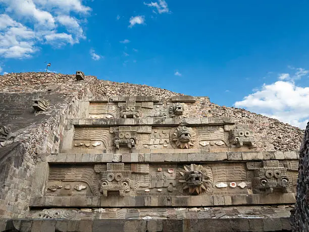 The pyramid of Quetzalcoatl (god of the "feathered serpent") is showing the alternating "Tlaloc" (left, with teeth, a god of rain, fertility, and water) and feathered serpent (right) heads. Dated to some time between 150 and 200 CE, it is part of the Unesco World Heritage site Teotihuacan, Mexico.