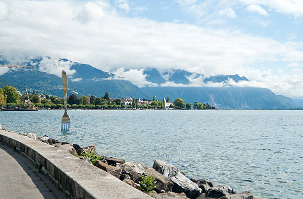 Vevey, Switzerland - September 14, 2011: Fork monument on Geneva Lake near Vevey. It was designed by Jean-Pierre Zaugg, a sculptor from Neuchatel, Switzerland and embedded in the lake in February 1995 to commemorate the Alimentarium’s (Food Museum) tenth anniversary.