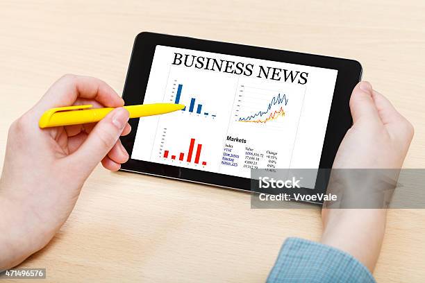 Touching By Pen Of Tablet Pc With Business News Stock Photo - Download Image Now - 2015, Adult, Analyzing