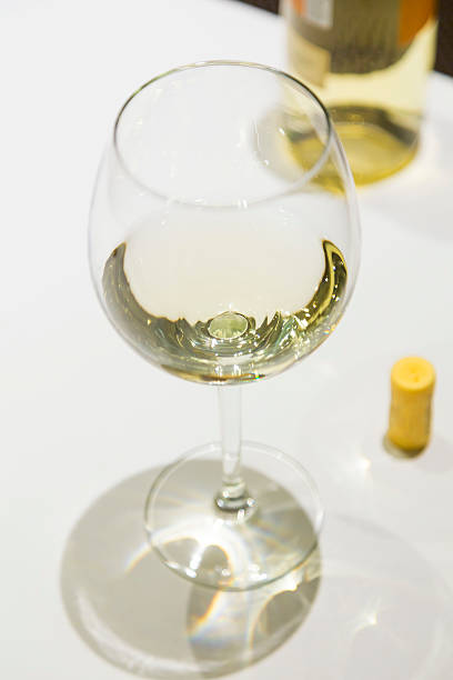 istock White wine on a wineglass on a vintage scene 471496886