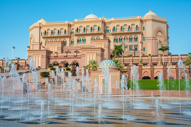 Emirates Palace illuminated at night timelapse, Abu Dhabi, United Arab Emirates. Lights reflected in water