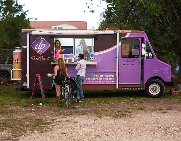 Gelato Food Truck Miami, USA - February 9, 2013: Customer ordering at a food truck. The "Dolci Peccati" gelato Food Truck participates in the Art Walk Wynwood Festival in the Miami Design District. This truck offers a variety of ice creams, popsicles, milkshake and frozen cakes and their motto is "The sweetest truck on the road" miami food truck stock pictures, royalty-free photos & images