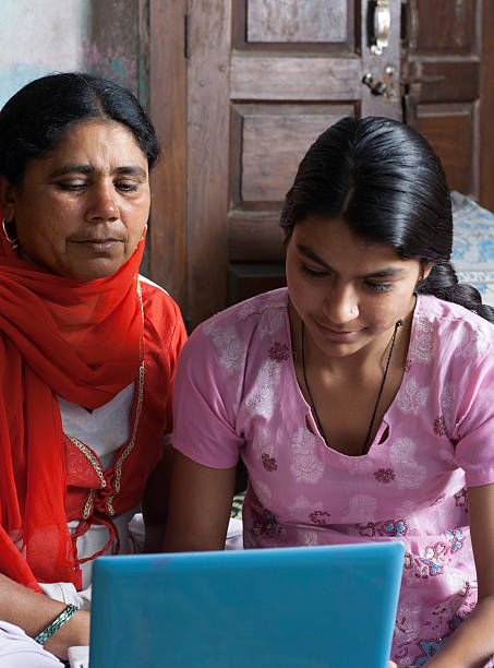 istock Rural Indian Women Using Laptop with Her Daughter. 471499299