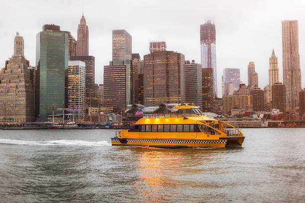 Water Taxi New York City Skyline Water Taxi cruising in front of Manhattan East Side towards Brooklyn, New York City Skyline at Sunset. New York City, USA. watertaxi stock pictures, royalty-free photos & images