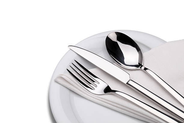istock Fork, knife and spoon on a plate with napkin 471499923