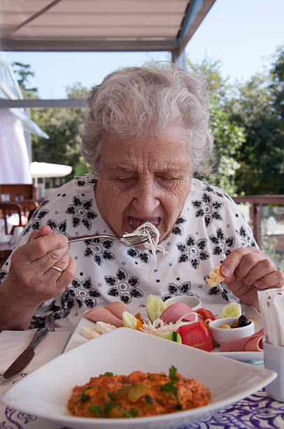 istock senior woman eating 471500113