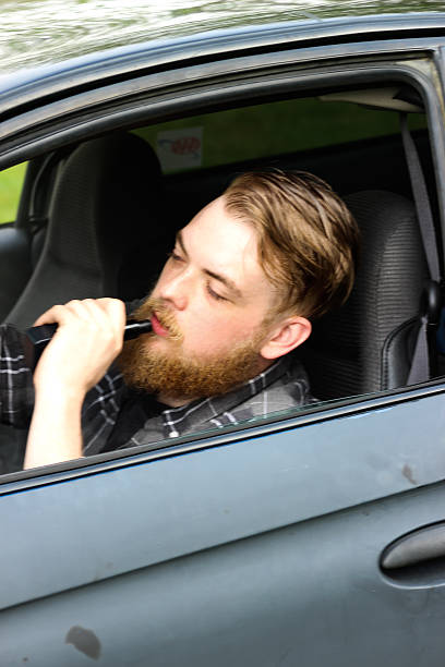 istock Man Vaping in His Old Car 471502042