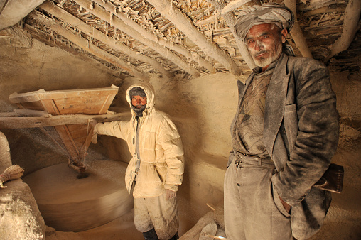 Band-e-Amir,  Afghanistan - November 15, 2010: Two Afghanistan millers in their traditional water mill 