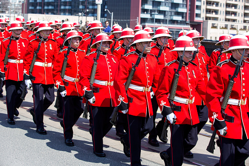 Toronto, Canada - April 27, 2013: Soldiers of the Royal Canadian Regiment march downtown Toronto in a parade commemorating the 200th anniversary of the Battle of York, during the War of 1812.