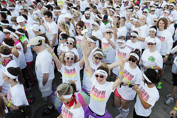 Runners anticipating the start of Color Run stock photo