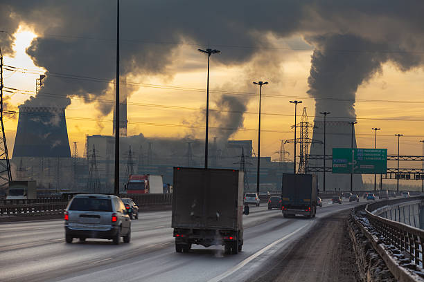Air pollution from factory with cars on road Saint-Petersburg, Russia - December 23, 2012: City ringway with cars and air pollution from heat electric generation plant.  Strong vapor and smoke due extreme cold weather city street street man made structure place of work stock pictures, royalty-free photos & images