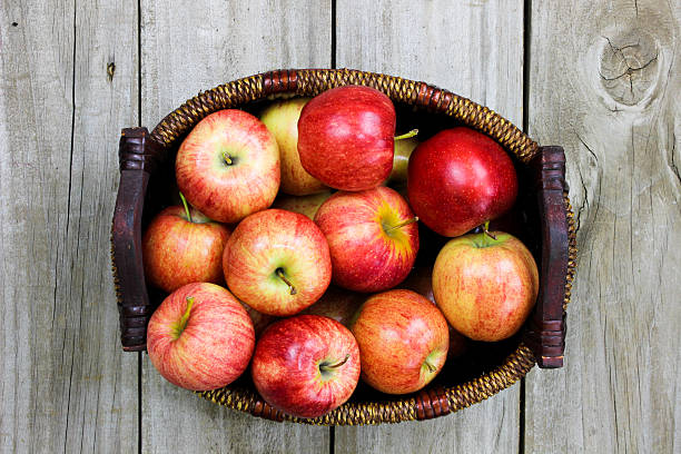 istock Basket of red gala apples on wood table 471503594
