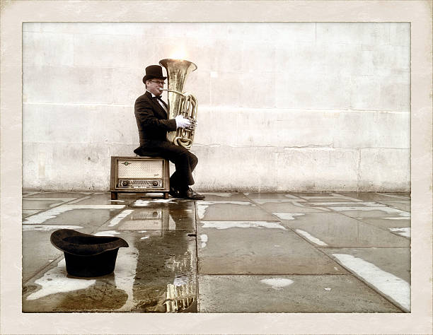 London, UK - 18 April 2013: Retro processing to an iPhone capture of a tuba player busking on the streets of London.  
