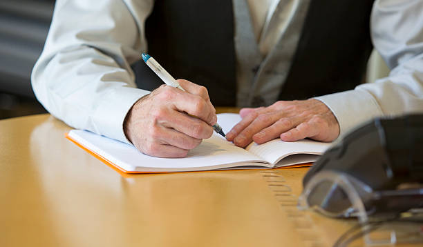 istock close-up of man's hands signing a paper 471504632