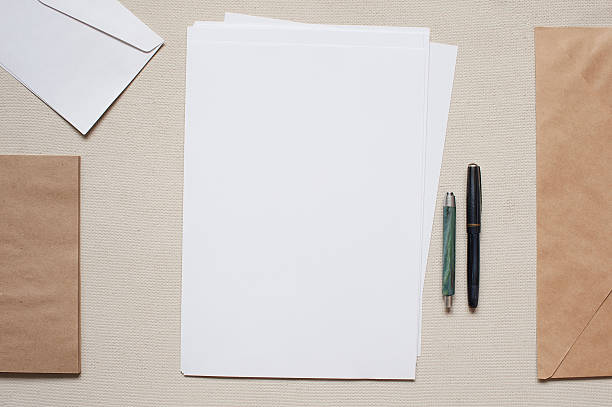 istock Blank sheets of paper and brown envelopes with pens 471504722