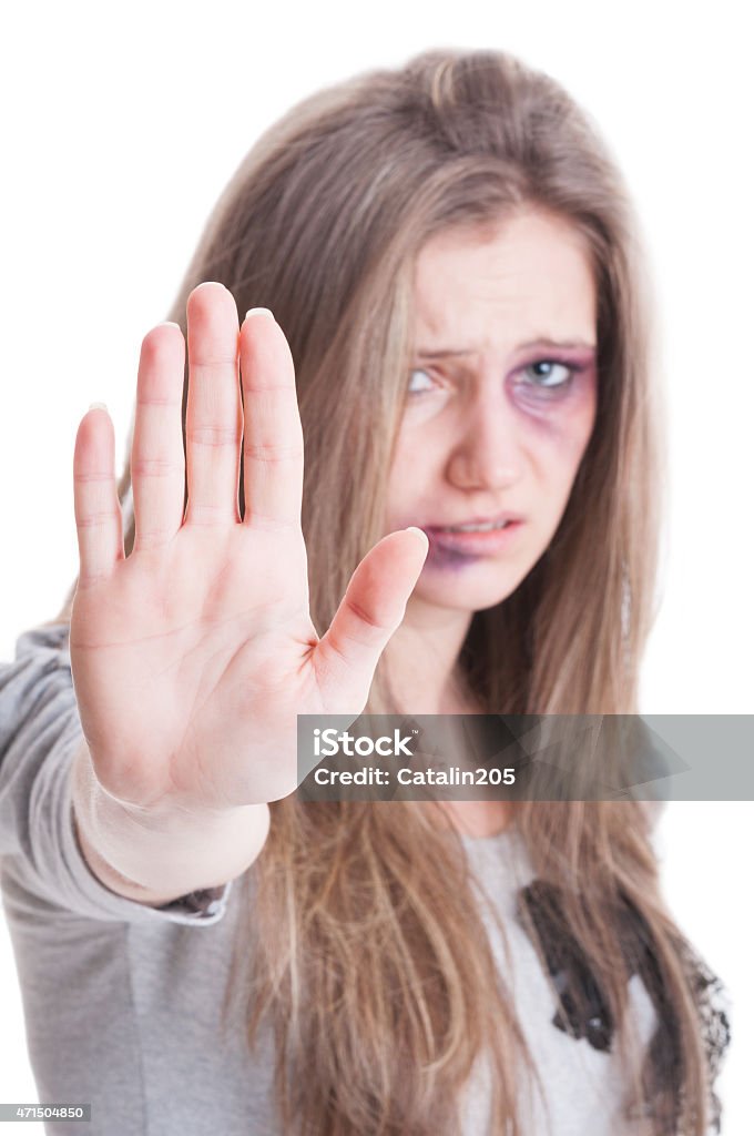 Stop domestic violence against women concept Stop domestic violence against women concept with an abused injured and bruised woman on white background 2015 Stock Photo