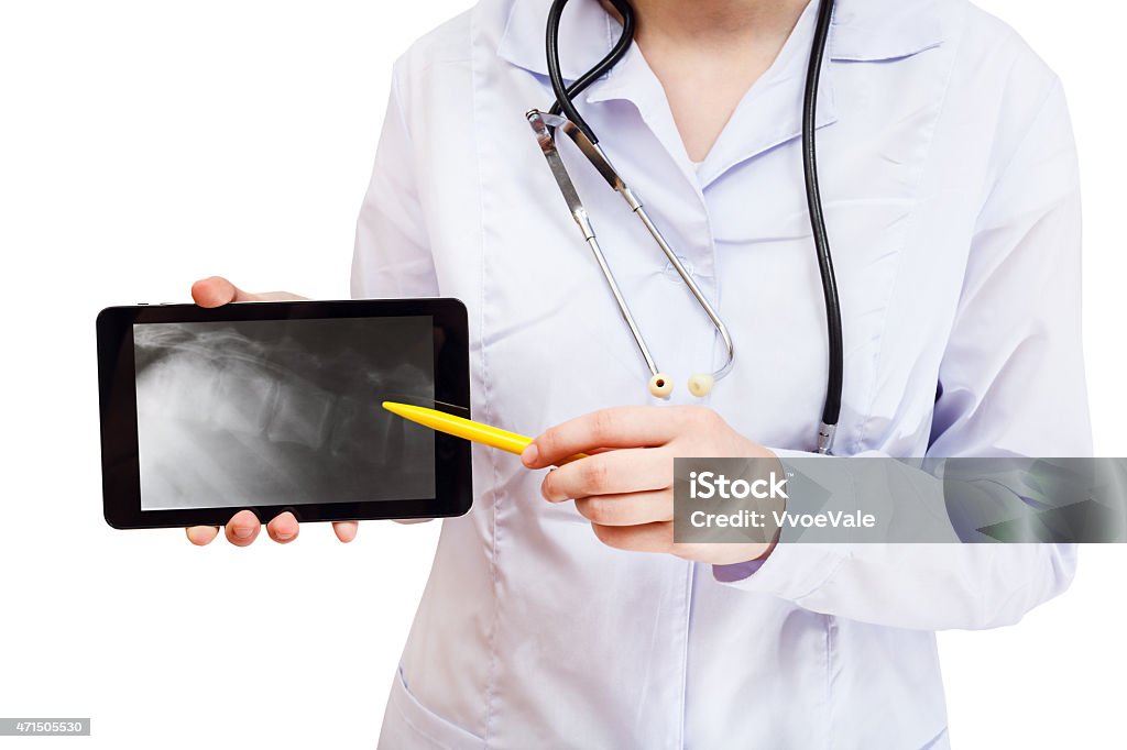 nurse points on tablet pc with vertebral column nurse points tablet pc with X-ray picture of human vertebral column on screen isolated on white background 2015 Stock Photo