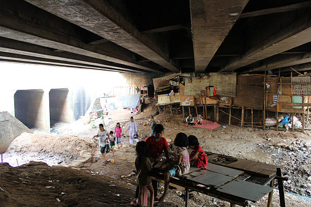 slums under the bridge Jakarta, Indonesia-July 11, 2013: Some children were playing under the bridge. There are many other less fortunate children living in slum houses jakarta slums stock pictures, royalty-free photos & images