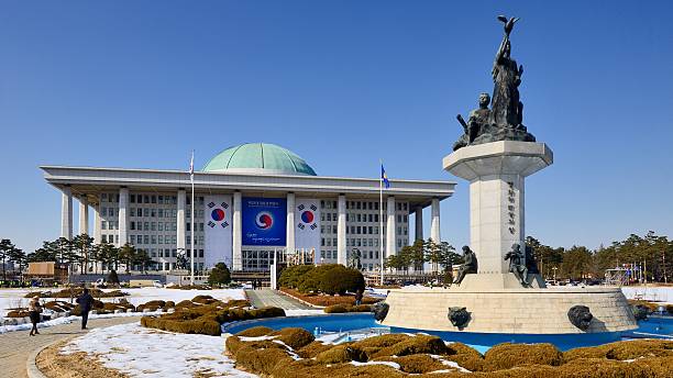 Seoul, South Korea - February 16, 2013: Visitors walk on the grounds of the National Assembly of South Korea. Completed in 1975, the building houses the activities of the 300-member unicameral legislature of South Korea.