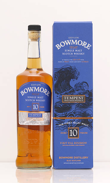 Bowmore whisky Bayreuth, Germany – April 01, 2013: Bottle and box of a 10 years old scotch single malt whisky from the distillery Bowmore, that is situated at the Scottish isle Islay. Edition Tempest bowmore whisky stock pictures, royalty-free photos & images