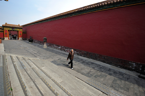 Beijing, China - April 1, 2013: People goes pass the alleyway inside The Forbidden City at Beijing on April 1. The Forbidden City was the palace for Chinese Emperors for almost 500 years.