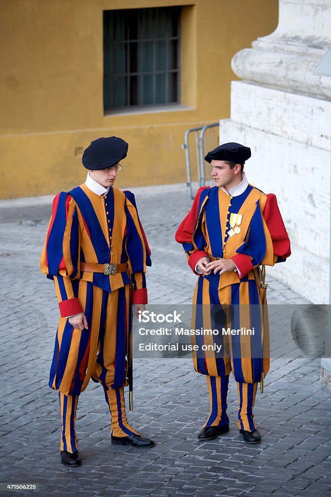 Swiss Guard Vatican City, Vatican City State - August 21, 2008: Members of the Corps of the Pontifical Swiss Guard, or Swiss Guard as commonly known, stands guard in the Vatican City near St. Peter's Basilica. Capital Cities Stock Photo