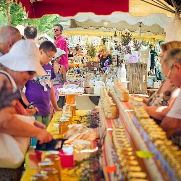 Paradou, France - July 15, 2012: People selling colorful soap bars, perfume, honey of lavender and other souvenirs at a farmer's market  in Provenve in summer