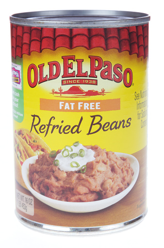 Montgomery, USA - May 2, 2013: A studio product shot of a fat free16 oz can of Old El Paso traditional refried beans. This product is distributed in America by General Mills Sales, Inc.