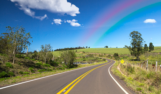 Amazing road with clouds and the rainbow