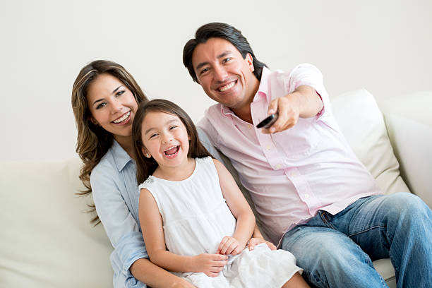 istock Family watching tv at home 471508270