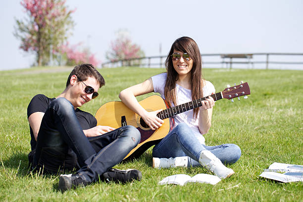 istock Young  playing acoustic guitar 471510194
