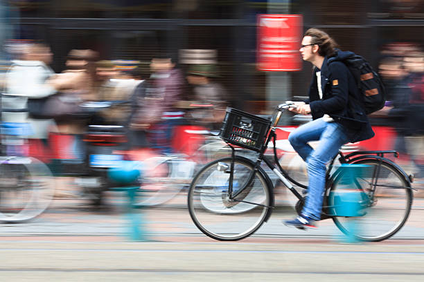 Amsterdam, Netherlands - April 13, 2013: man riding a bicycle down the street
