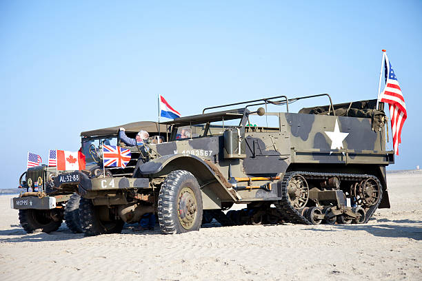 IJmuiden, The Netherlands-May 5 2013: Army trucks of organization Kelly's Heroes riding on beach on May 5,2013 in IJmuiden, The Netherlands. Simulate arrival of allies on liberation Second World War
