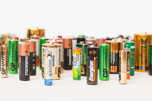 Oslo, Norway - May 5, 2013:Collection of different battery brands. Maxell, Duracell, Fuji, GP, Kodac, Varta, Philips and others on white background.