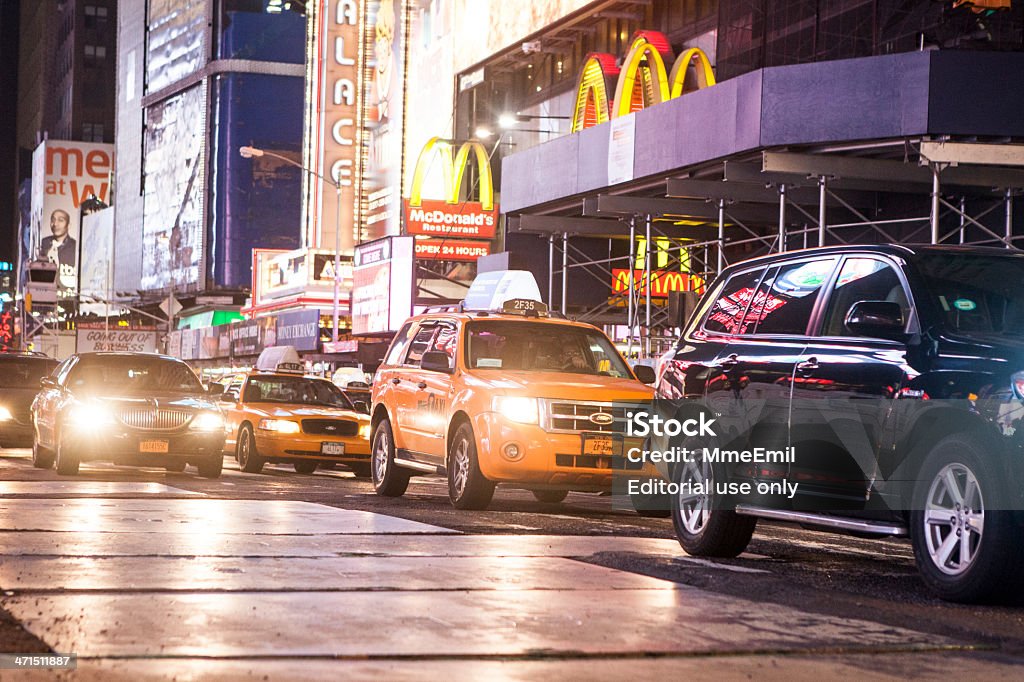 Time Square At Night New York, United States- April 18, 2013: Yellow taxi cab and traffic crossing Time Square at night. 7th Avenue Stock Photo