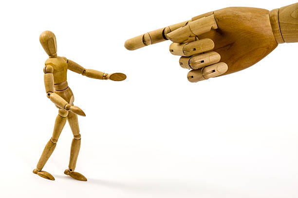 istock Wooden big hand directing to small dummy guy 471512027