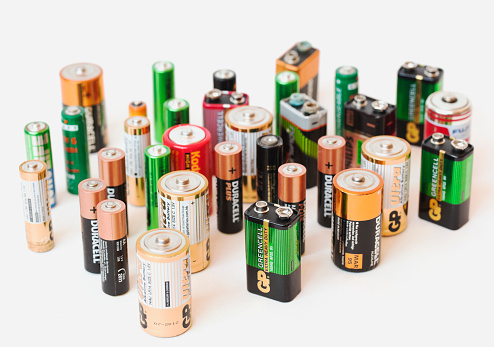 Oslo, Norway - May 5, 2013:Collection of different  colorful battery brands as  Duracell, GP, Kodac, Ucar  Varta, Philips and others  standing on white background.