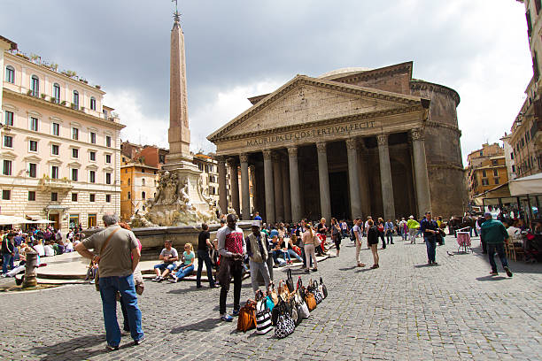 Rome, Italy- April 19, 2015: Men selling knock-off bags and purses at the Pantheon in Rome, Italy.