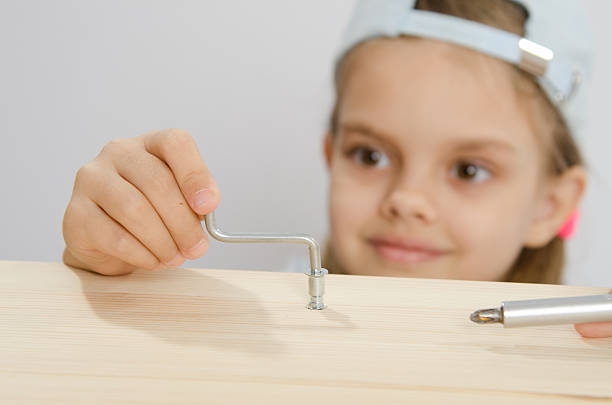 istock Girl in the classroom working spins screw 471513698