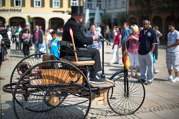 Benz Patent Motor Car Ludwigsburg, Germany - May 5, 2013: A replica of a Benz Patent-Motorwagen is presented during the eMotionen show on the market square on May 5, 2013 in Ludwigsburg, Germany. The Benz Patent-Motorwagen Number 1 is the first car using a combustion engine and was built in 1886. The eMotionen show was presenting classic cars and modern electronic cars during a shopping Sunday with the stores in Ludwigsburg opening their doors. coach bus stock pictures, royalty-free photos & images