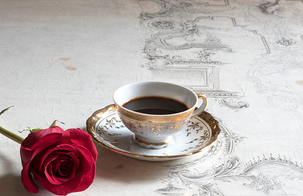 istock cup of coffee on the table with rose flower 471514896
