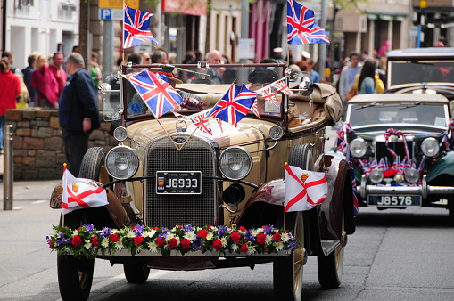 Jersey, U.K. - May 9, 2013: Decorated vintage motorcade on the streets of Jersey on Liberation Day in remembrance of the World War Two occupation