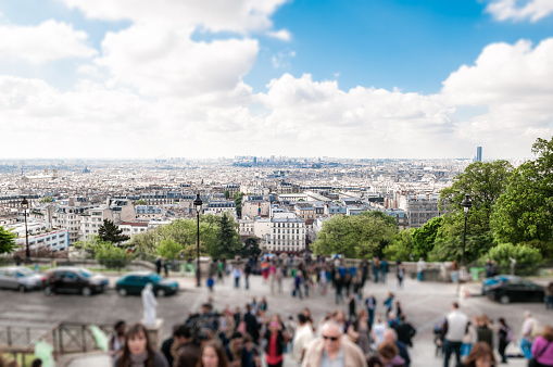Paris , France - May 12, 2012:  View over Paris city centre seen from the stairs of Montmarte hill leading to Sacre Couer basilica.Tourist in foreground are heeding to the church