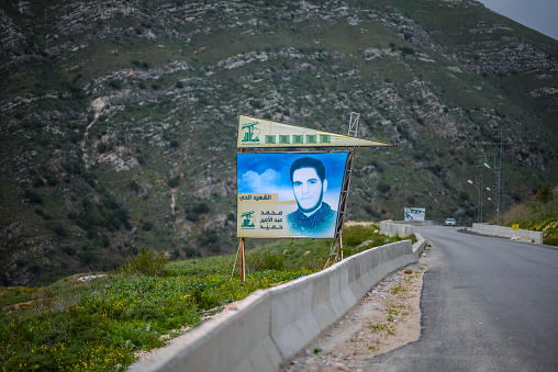 Near Bent Jbai, Lebanon – February 28, 2013: A billboard  for a Hezbollah fighter who gave his life for the cause of the so-called «Party of God».A common scene in Hezbollah-controlled south Lebanon.