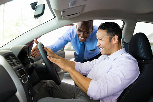 istock african salesman explaining car features to customer 471516944