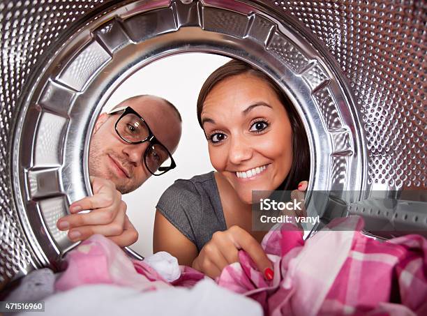 Young Couple Doing Laundry Stock Photo - Download Image Now - Couple - Relationship, Dryer, Washing Machine