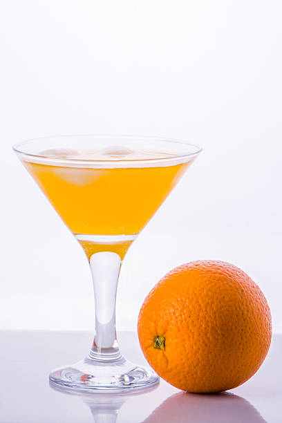 istock orange with glass of juice with ice on white 471519062