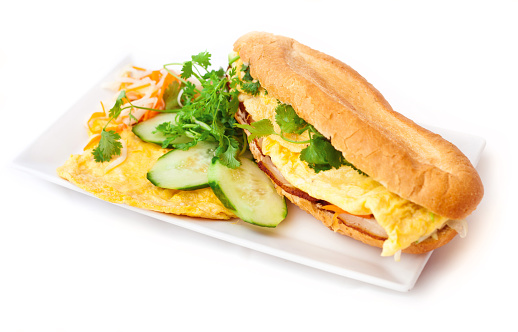 Banh mi ¬ vietnamese baguettes sandwiches  on white background. Banh mi - white baguettes prepared with eggs. Decorated with fresh coriander.
