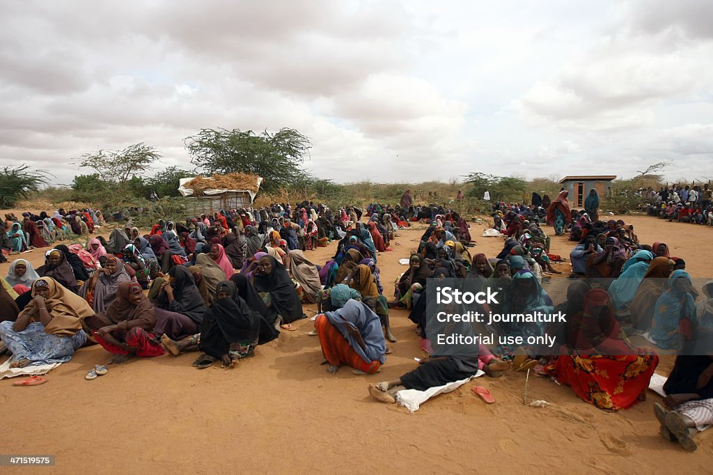 Famine in Africa Dadaab Refugee Camp Dadaab, Kenya - August 14, 2011: A newly arrived Somali refugees waits following their registration and food on August 14, 2011 at the Dadaab refuge complex. UN Under-Secretary-General for Humanitarian Affairs and Emergency Relief Coordinator Valerie Amos toured today the refuge complex holding more that 440,000 refugees during the third day of her visit to southern Somalia and to the Kenya-hosted refugee complex to asses the impact of the famine. Her visit comes as the UN said its moving on two fronts to counter the worsening food crisis in the Horn of Africa, with an immediate infusion of food in an area where 640,000 children alone are threatened with acute malnutrition. Refugee Camp Stock Photo