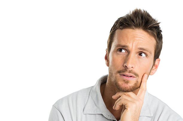 istock A pondering young man with hand on chin isolated on white 471519687